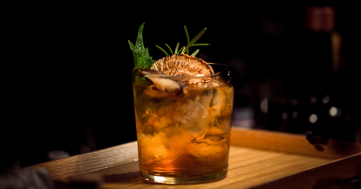 A well-stocked home bar with quality spirits, cocktail tools, and elegant glassware on a stylish bar cart
