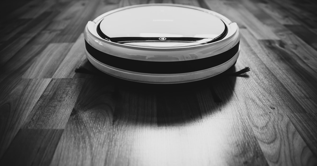 Robot vacuum and cordless vacuum side by side on carpet