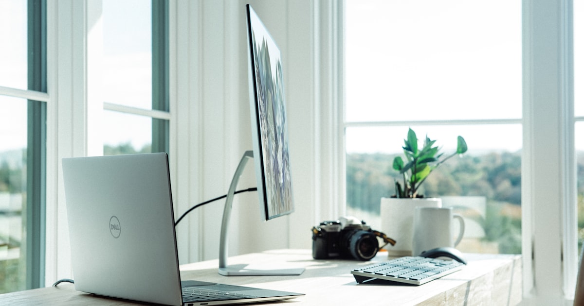 Standing desk next to desk with sit-stand converter showing height comparison